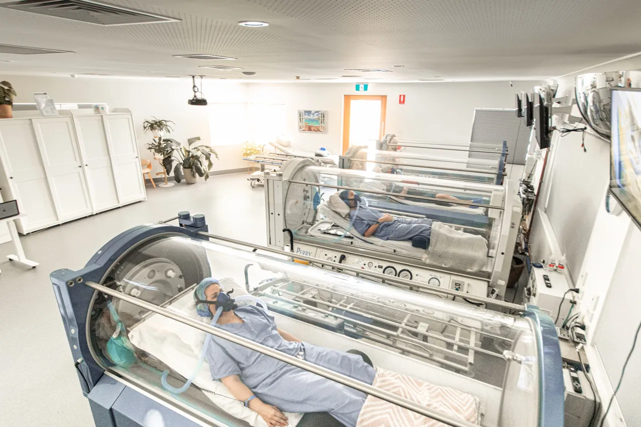 Hyperbaric oxygen therapy room with patients resting in chambers at the Gold Coast clinic